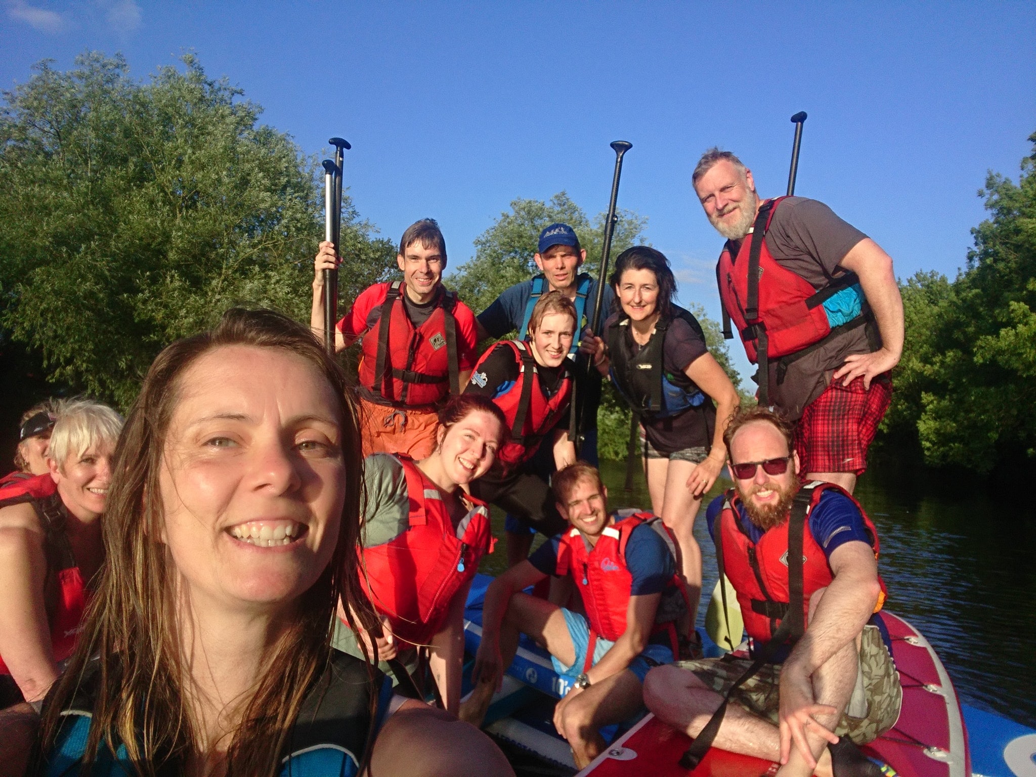 Group of people having fun learning paddleboarding