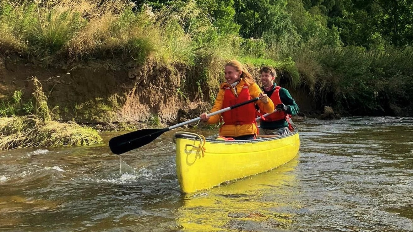 couple in yellow hire canoe