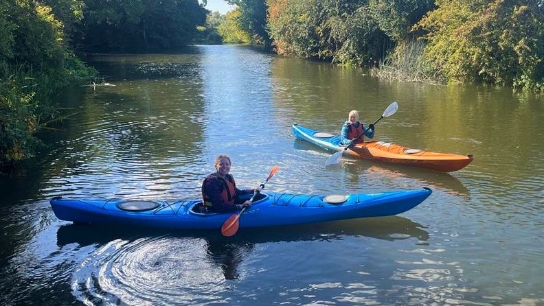 two ladies in blue hire kayaks
